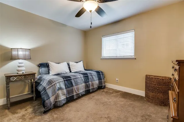 a spacious bedroom with a bed and a chandelier