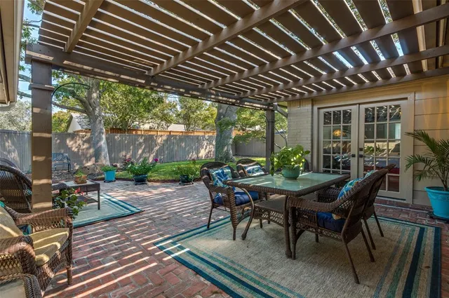 a patio with glass top table and chairs