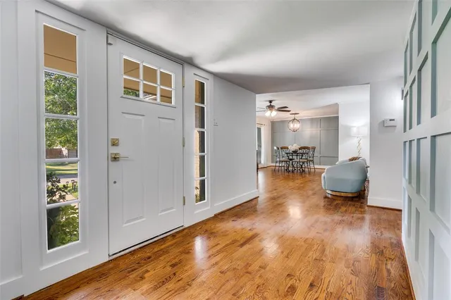 a view of a livingroom with wooden floor and a window