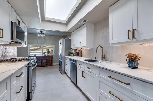 a kitchen with a sink stove and cabinets
