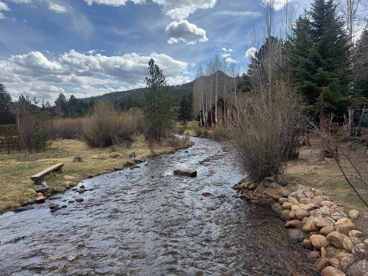 2100 Fall River Road, Unit 4 Estes Park, CO 80517 - Photo 1 of 28 a view of a dry yard with wooden fence