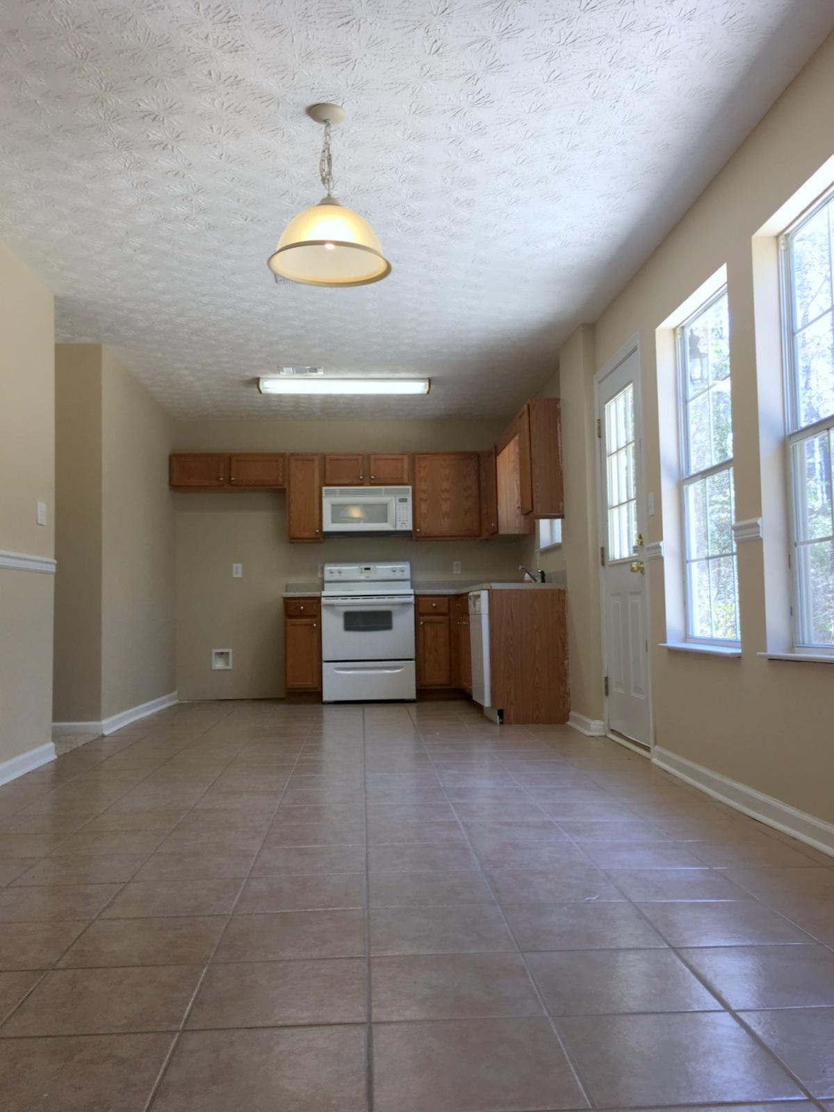 599 Bay Grove Road Freeport, FL 32439 - Photo 8 of 29 a view of a kitchen with a stove cabinets and a ceiling fan