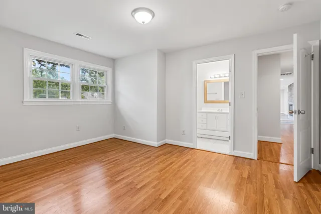 a bathroom with a toilet a sink a tub and mirror