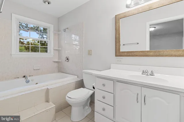 a view of a big room with windows and chandelier