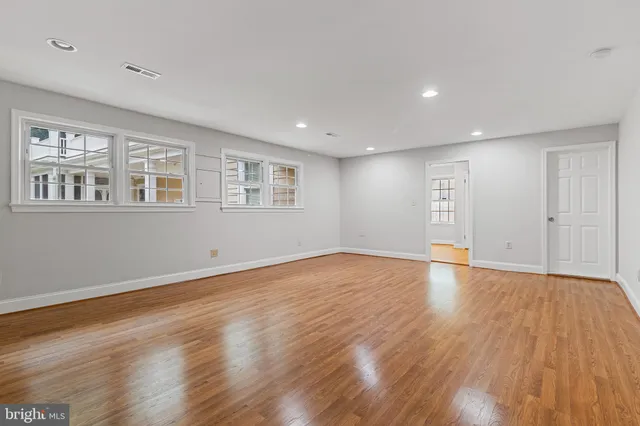 a view of a porch with a door and wooden floor