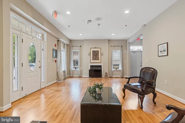 a view of entryway and hall with wooden floor