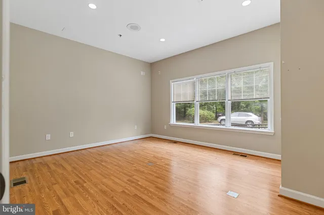 a large kitchen with stainless steel appliances granite countertop a stove top oven a sink dishwasher a refrigerator and a microwave