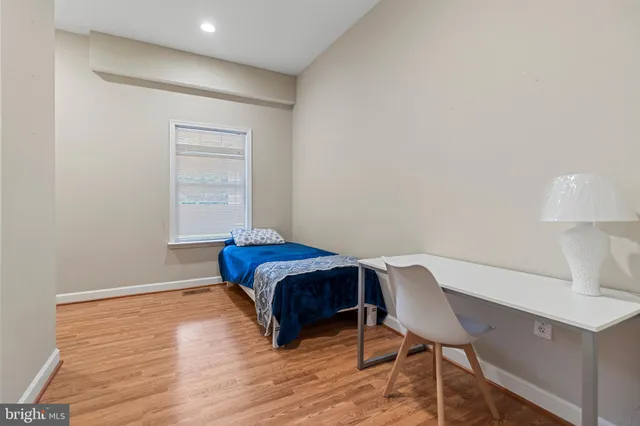 a bathroom with a granite countertop sink a toilet and a mirror