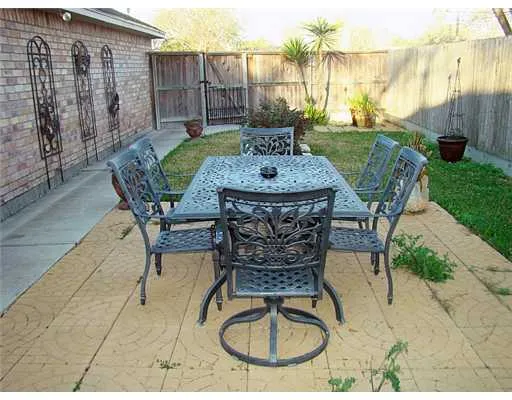 a patio with a table and chairs