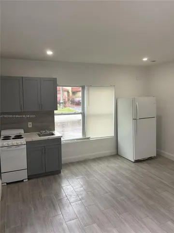 a kitchen with granite countertop a stove and a refrigerator