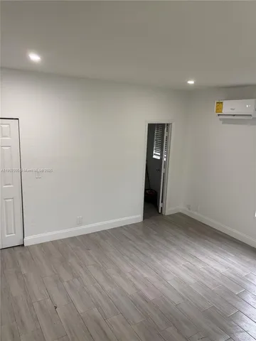 an empty room with wooden floor and closet