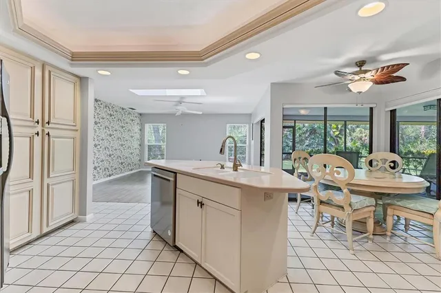 a very nice looking dining room with a large window and chandelier