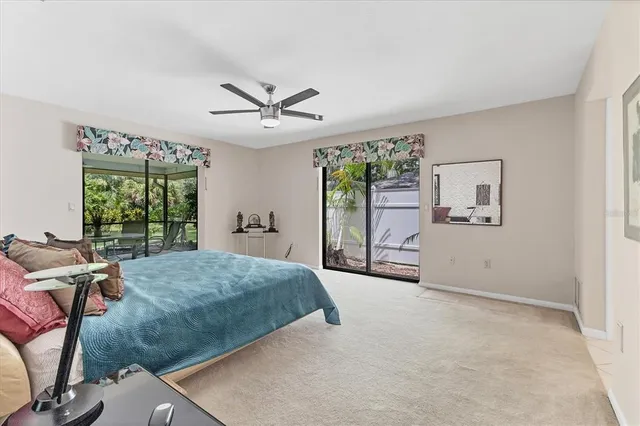 a spacious bedroom with a large bed and a chandelier