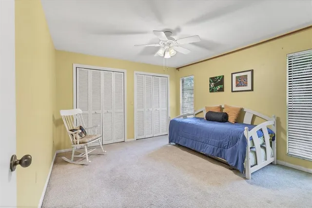 a spacious bedroom with a bed and a chandelier