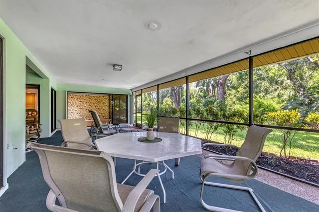 a dining room with furniture window and outside view