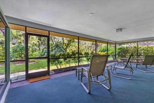 a living room with couch and a floor to ceiling window