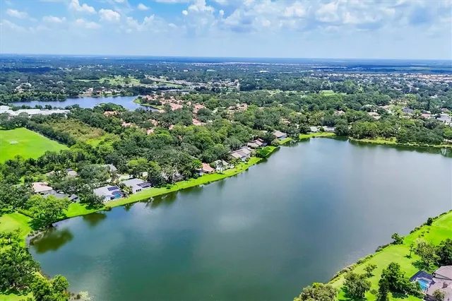 an aerial view of a houses with a lake view