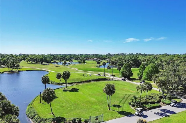 an aerial view of a golf course with a swimming pool