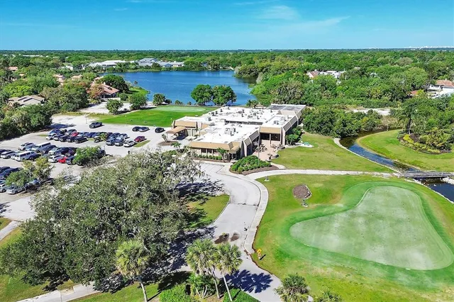 an aerial view of a house with a garden and lake view