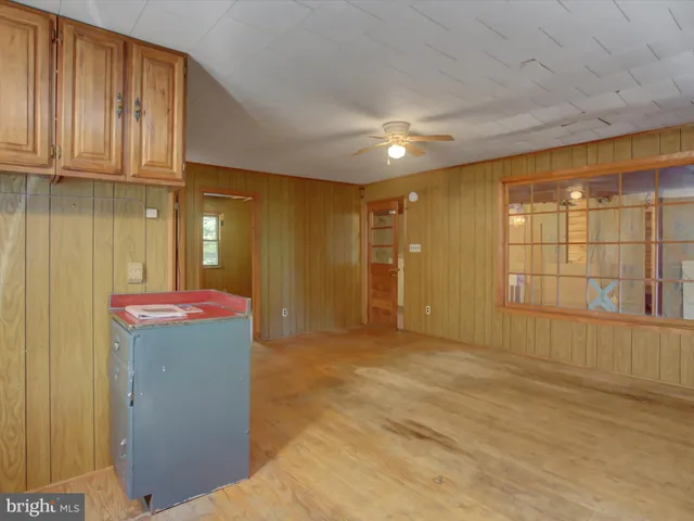 a view of a livingroom with an empty space and window