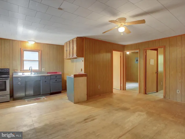 a view of a kitchen with a sink cabinets and front door