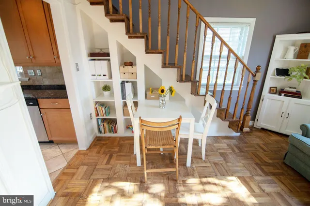 a dining room with furniture and wooden floor