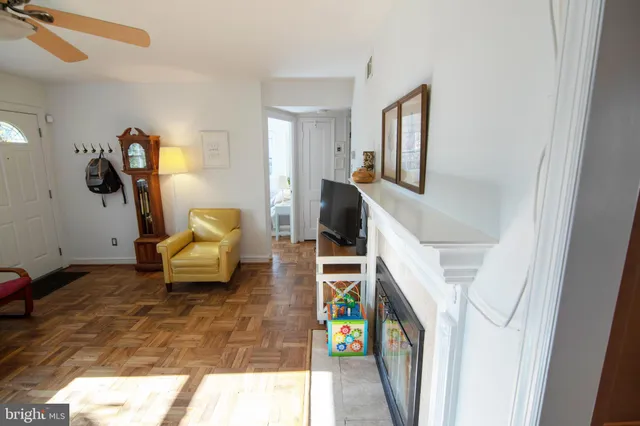 a living room with furniture and a baby crib