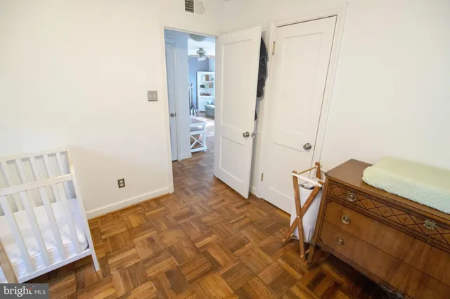 a bathroom with a granite countertop toilet and a sink