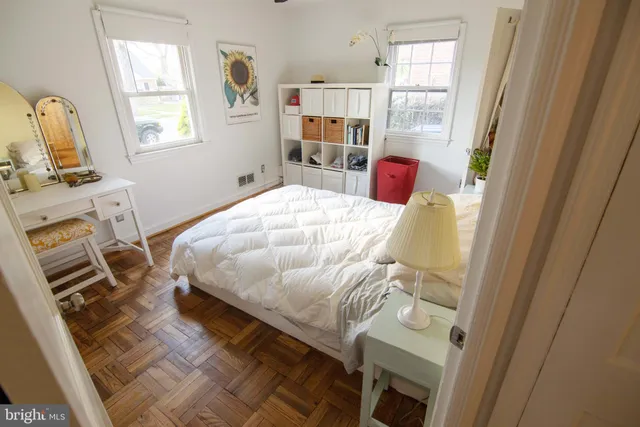 a bed sitting in a bedroom next to a window