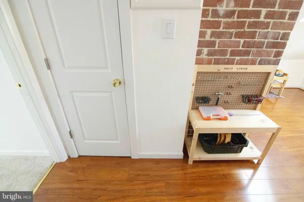 a view of a bedroom with wooden floor and bed