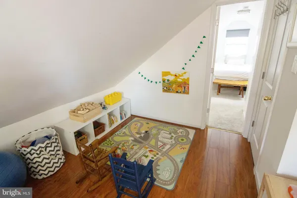 a room with a wooden floor and a sink