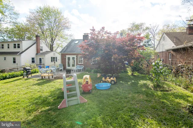 a backyard of a house with table and chairs