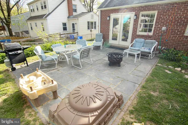 a view of backyard of house with seating space
