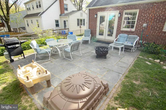a view of backyard of house with seating space
