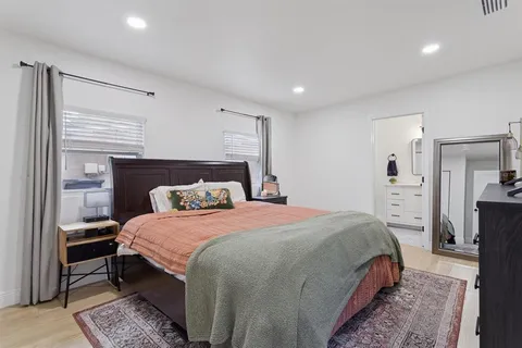 a bedroom with a bed and a dresser