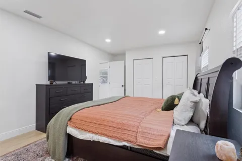 a bedroom with a bed and a flat screen tv