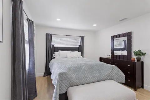 a bedroom with a bed and a potted plant