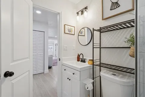 a bathroom with a sink a toilet and a mirror