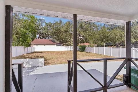 a view of a balcony with floor to ceiling windows with wooden floor