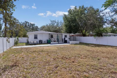 a view of a house with backyard and sitting area