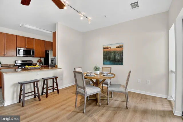 a dining room with furniture and wooden floor
