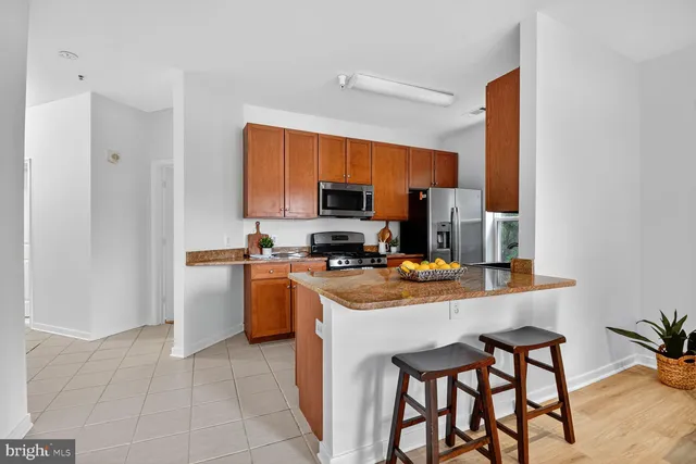 a kitchen with a stove a sink and a refrigerator