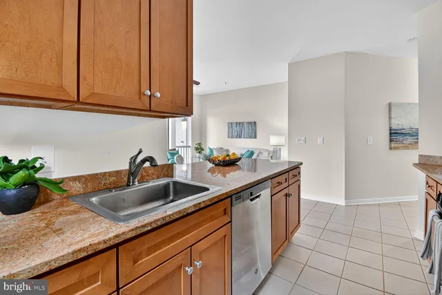 a kitchen with stainless steel appliances granite countertop a sink and a white cabinets