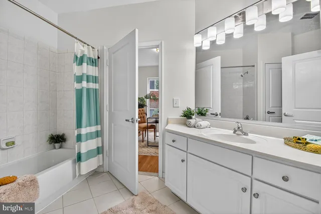 a spacious bathroom with a shower sink and mirror