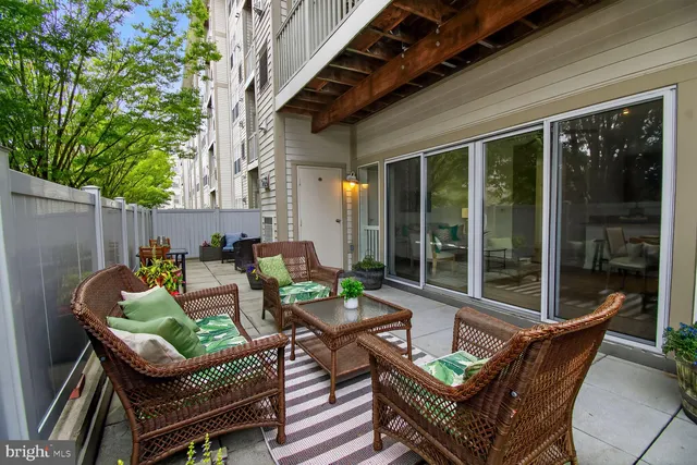 a backyard of a house with barbeque oven table and chairs
