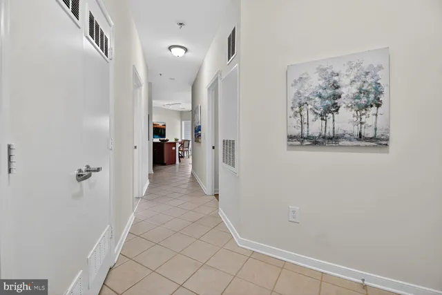 a view of a hallway with closet and bathroom