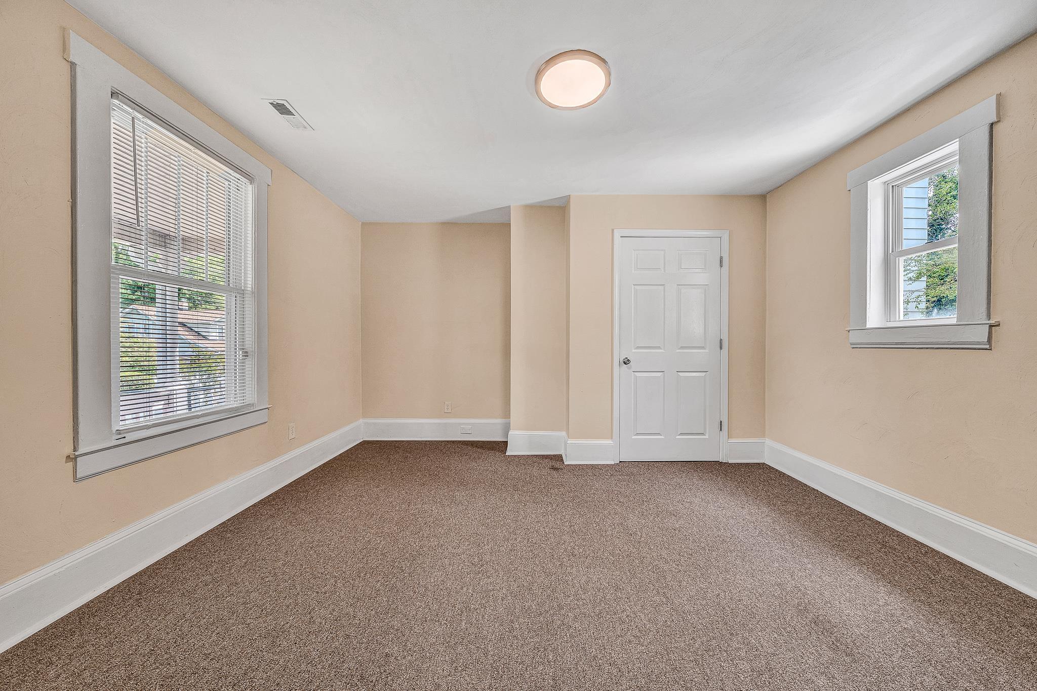 528 Rutherford Avenue Northwest Roanoke, VA 24016 - Photo 6 of 13 an empty room with windows