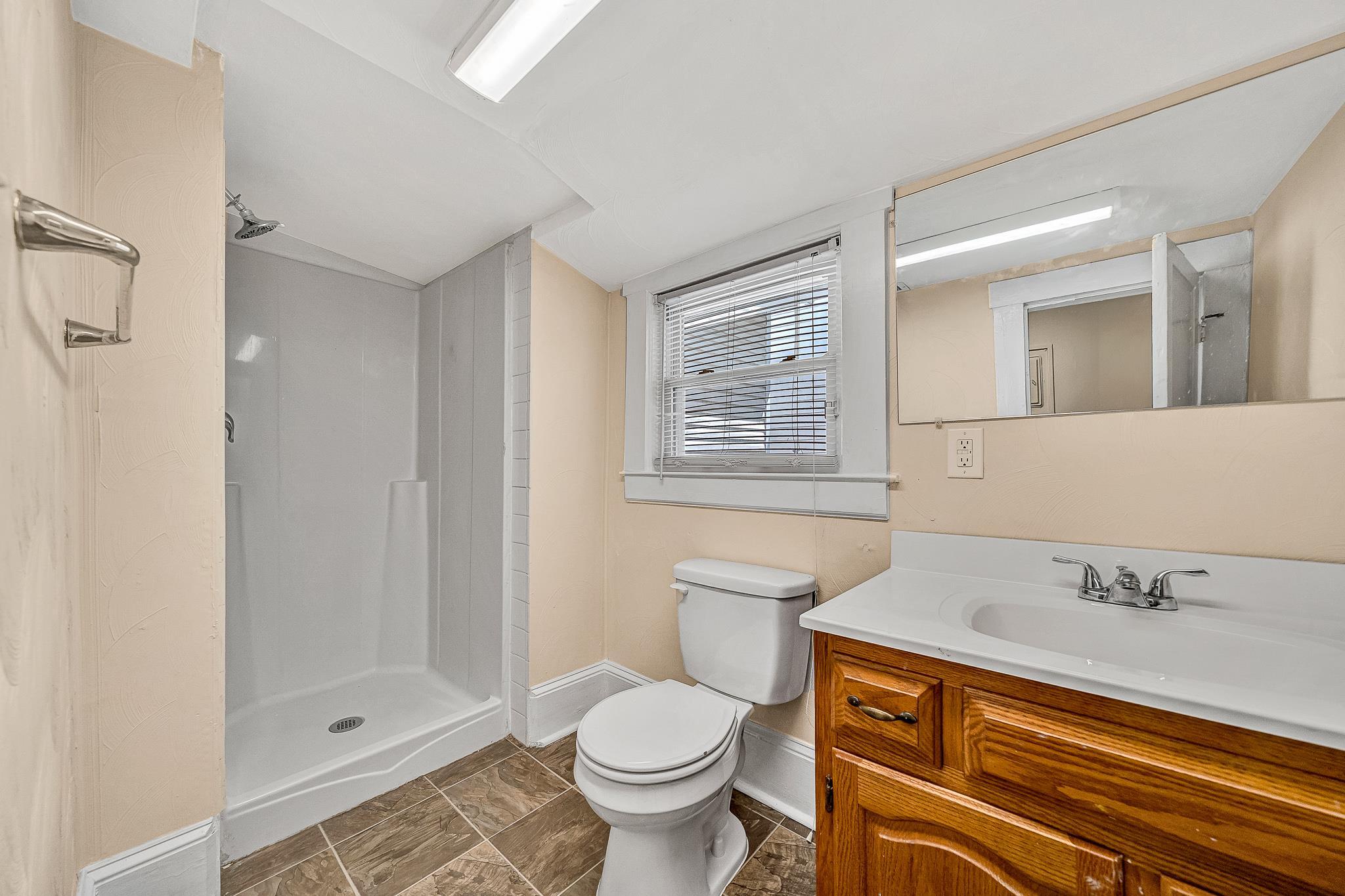 528 Rutherford Avenue Northwest Roanoke, VA 24016 - Photo 7 of 13 a bathroom with a sink toilet and shower