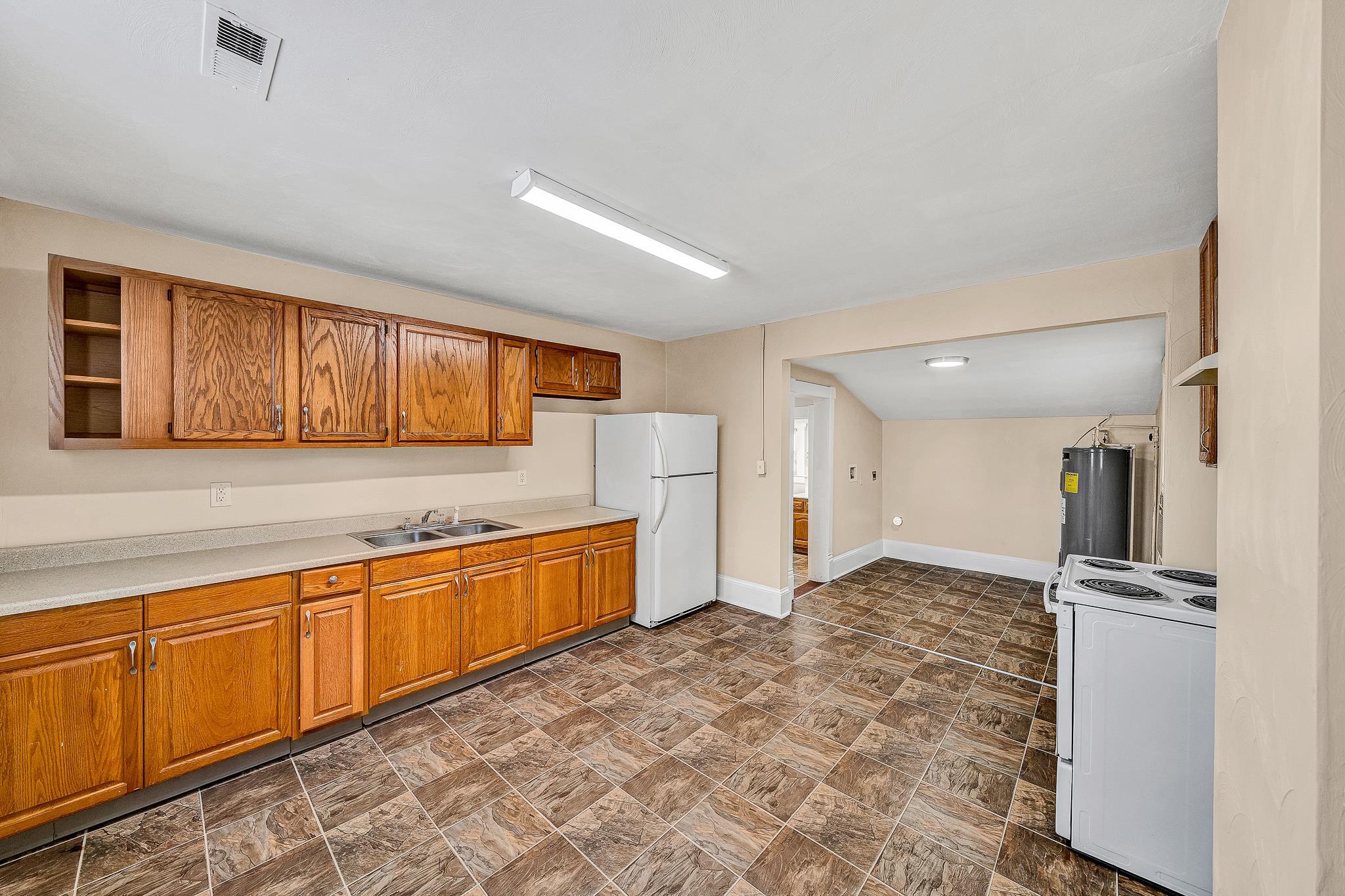 528 Rutherford Avenue Northwest Roanoke, VA 24016 - Photo 9 of 13 a large kitchen with stainless steel appliances granite countertop a refrigerator and a sink