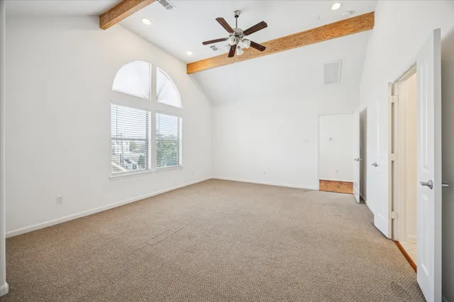 a spacious bathroom with a granite countertop double vanity sink a mirror and a bathtub